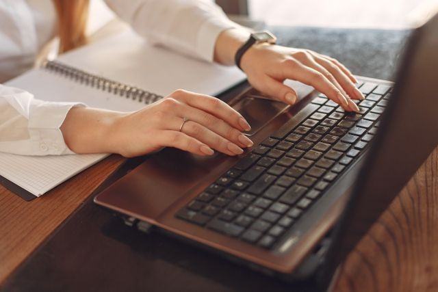 person typing on a laptop 