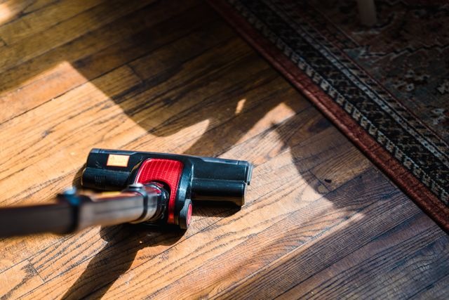 person vacuuming a hardwood floor